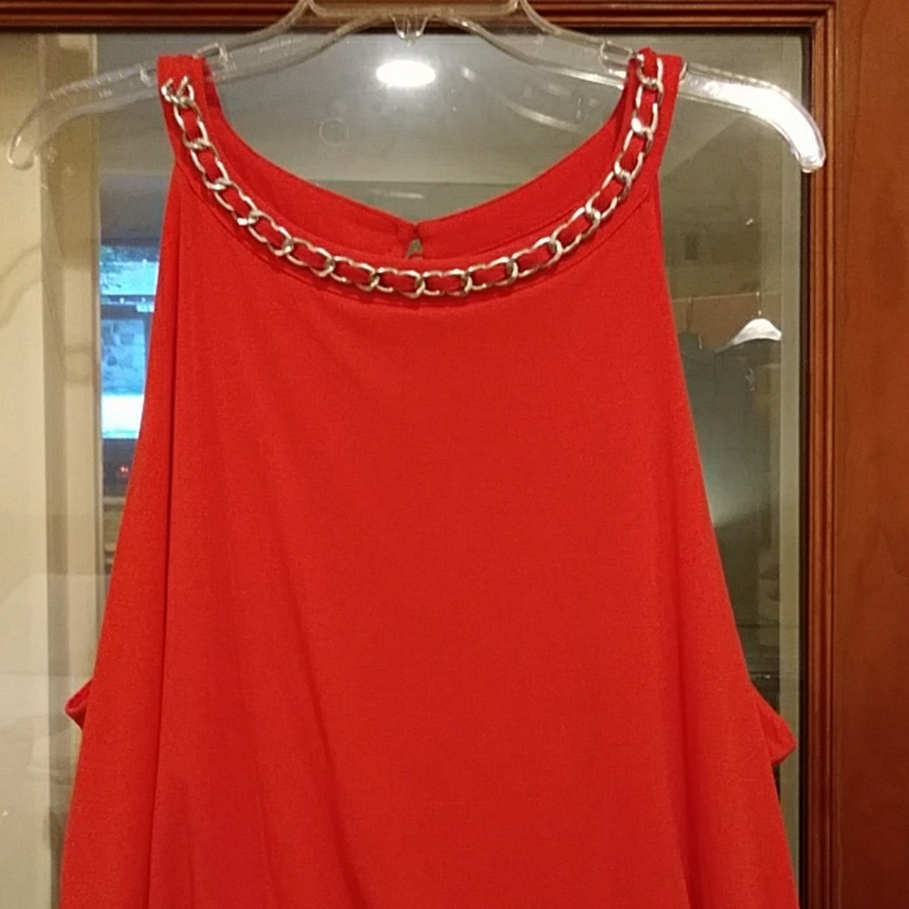 Styling Co orange jumpsuit with silver chain neckl